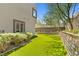 An expansive backyard showcases artificial turf, desert landscaping, and a privacy wall at 865 Auroras Edge Ct, Henderson, NV 89012