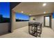 Relaxing outdoor balcony with a modern table set and stunning city views through a large picture window at 865 Auroras Edge Ct, Henderson, NV 89012