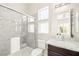 Modern bathroom with a glass-enclosed shower, granite counters, and ample natural light at 865 Auroras Edge Ct, Henderson, NV 89012