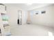 Well-lit bedroom with three windows and a floral chair at 865 Auroras Edge Ct, Henderson, NV 89012
