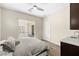 A comfortable bedroom features a ceiling fan, built-in desk, and access to the patio at 865 Auroras Edge Ct, Henderson, NV 89012