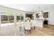 Eat-in kitchen area with backyard view, modern lighting, stainless hood, and white island with seating at 865 Auroras Edge Ct, Henderson, NV 89012