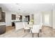 Well-lit eat-in kitchen features stainless appliances, granite counters and a view of the entry hallway at 865 Auroras Edge Ct, Henderson, NV 89012