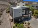 Modern home with a three-car garage, desert landscaping, gravel accents, and a fenced perimeter at 865 Auroras Edge Ct, Henderson, NV 89012