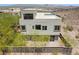 Contemporary home with large windows, a second-story patio, and landscaped yard in an elevated community at 865 Auroras Edge Ct, Henderson, NV 89012