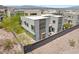 Modern home features a multi-level design with stone accents, a courtyard with firepit, desert landscaping, and a privacy wall at 865 Auroras Edge Ct, Henderson, NV 89012