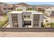 Modern home features a multi-level design with stone accents, a courtyard with firepit, and a privacy wall at 865 Auroras Edge Ct, Henderson, NV 89012