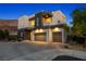 Modern two-story home with a three-car garage and desert landscaping at 865 Auroras Edge Ct, Henderson, NV 89012