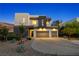 Gorgeous two-story home featuring desert landscaping, a three-car garage and nice hardscape at 865 Auroras Edge Ct, Henderson, NV 89012