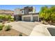 Stunning two-story home featuring a three-car garage and desert landscaping at 865 Auroras Edge Ct, Henderson, NV 89012