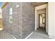 An inviting exterior showcases stone accents and an arched entry to the home at 865 Auroras Edge Ct, Henderson, NV 89012