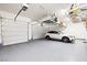 Three car garage features epoxy flooring and overhead storage shelves at 865 Auroras Edge Ct, Henderson, NV 89012