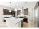 Spacious kitchen with stainless appliances, granite counters and modern lighting fixtures at 865 Auroras Edge Ct, Henderson, NV 89012