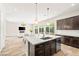 Open-concept kitchen and living space featuring a granite island and modern finishes at 865 Auroras Edge Ct, Henderson, NV 89012