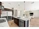 Modern kitchen features stainless appliances, a granite island, and dark wood cabinetry at 865 Auroras Edge Ct, Henderson, NV 89012