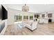 Bright and airy living room with wood floors and sliding glass doors to the outside at 865 Auroras Edge Ct, Henderson, NV 89012