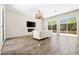 Open living room featuring wood flooring and a wall of sliding glass doors to the backyard at 865 Auroras Edge Ct, Henderson, NV 89012