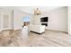 Open-concept living room with light wood-look flooring, modern lighting, and sliding door access to the backyard at 865 Auroras Edge Ct, Henderson, NV 89012