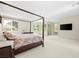 A spacious main bedroom with a four-poster bed, offering a serene retreat at 865 Auroras Edge Ct, Henderson, NV 89012