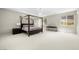 This primary suite boasts a four-poster bed and ample natural light with carpet at 865 Auroras Edge Ct, Henderson, NV 89012