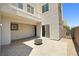 A covered outdoor patio with sleek paving stones, a fire pit, and access to a balcony at 865 Auroras Edge Ct, Henderson, NV 89012