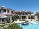 Aerial view of a luxury home with a waterfront and a resort-style pool and patio area at 8725 Newport Isle Ct, Las Vegas, NV 89117