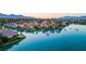 Panoramic aerial view showcasing the waterfront homes and community, highlighting the serene lake and mountain backdrop at 8725 Newport Isle Ct, Las Vegas, NV 89117