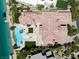 Aerial showcasing tile roof, pool, backyard, and lake access, highlighting the property layout and features at 8725 Newport Isle Ct, Las Vegas, NV 89117