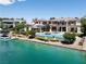 Aerial of stunning home showcasing a pool, waterfront access, and meticulous landscaping at 8725 Newport Isle Ct, Las Vegas, NV 89117
