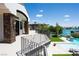 Upper balcony overlooking the pool and waterfront, with stone accents at 8725 Newport Isle Ct, Las Vegas, NV 89117