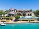 Stunning lakefront home with a private pool, boat dock, and lush landscaping, offering an idyllic outdoor lifestyle at 8725 Newport Isle Ct, Las Vegas, NV 89117
