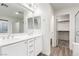Well-lit bathroom with dual sinks, modern fixtures, and a glass-enclosed shower with walk in closet at 9006 Cedar Door Ave, Las Vegas, NV 89148