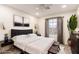 Inviting bedroom featuring a modern bed, window, and elegant decor at 9006 Cedar Door Ave, Las Vegas, NV 89148