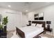 This bedroom features a ceiling fan, natural light, and a contemporary design with dark wood accents at 9006 Cedar Door Ave, Las Vegas, NV 89148