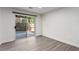 Clean dining room area featuring a sliding glass door and wood floors at 9006 Cedar Door Ave, Las Vegas, NV 89148