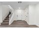 Welcoming foyer with neutral walls, durable laminate flooring, and stairs leading to the upper level at 9006 Cedar Door Ave, Las Vegas, NV 89148