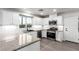 Modern kitchen with white cabinets, stainless steel appliances, and granite countertops at 9006 Cedar Door Ave, Las Vegas, NV 89148