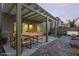 Outdoor patio with pergola, dining area, brick accents, and a well-maintained backyard at 9006 Cedar Door Ave, Las Vegas, NV 89148