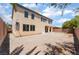 Large backyard and exterior view of a two-story home with covered patio at 9319 White Waterfall Ave, Las Vegas, NV 89149