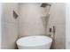 A serene bathroom featuring modern fixtures, including a standalone tub and rainfall shower head at 9319 White Waterfall Ave, Las Vegas, NV 89149