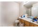 Bathroom with a vanity, toilet, and mirror; needs cleaning and organization at 9319 White Waterfall Ave, Las Vegas, NV 89149