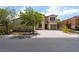 Two-story home with a desert landscape, one car garage, and a large driveway at 9319 White Waterfall Ave, Las Vegas, NV 89149