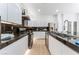 Bright kitchen features stainless steel appliances, granite countertops and white cabinetry at 9319 White Waterfall Ave, Las Vegas, NV 89149
