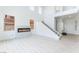 Spacious living room with a modern fireplace, staircase, and high ceilings at 9319 White Waterfall Ave, Las Vegas, NV 89149
