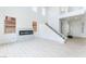 Spacious living room with a modern fireplace, staircase, and high ceilings at 9319 White Waterfall Ave, Las Vegas, NV 89149