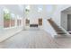 Spacious living room features a modern fireplace, many windows, and a staircase at 9319 White Waterfall Ave, Las Vegas, NV 89149