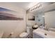 Bathroom with vanity, toilet, and decorative artwork, creating a stylish and functional space at 9333 Dry Dock Dr, Las Vegas, NV 89117