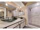 Modern bathroom with sleek glass vessel sinks, a spacious vanity, and a marble-tiled shower at 9333 Dry Dock Dr, Las Vegas, NV 89117