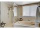 Bathroom featuring a soaking tub next to a window and a glass enclosed shower with tiled walls at 9333 Dry Dock Dr, Las Vegas, NV 89117