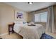 Inviting bedroom with soft bedding, a decorative painting, and ample natural light from the window at 9333 Dry Dock Dr, Las Vegas, NV 89117